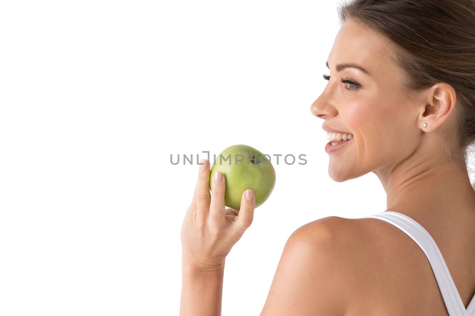 Beautiful smile, white strong teeth. Head and shoulders of young woman with snow-white toothy smile holding green apple, teethcare. Studio isolated on white background