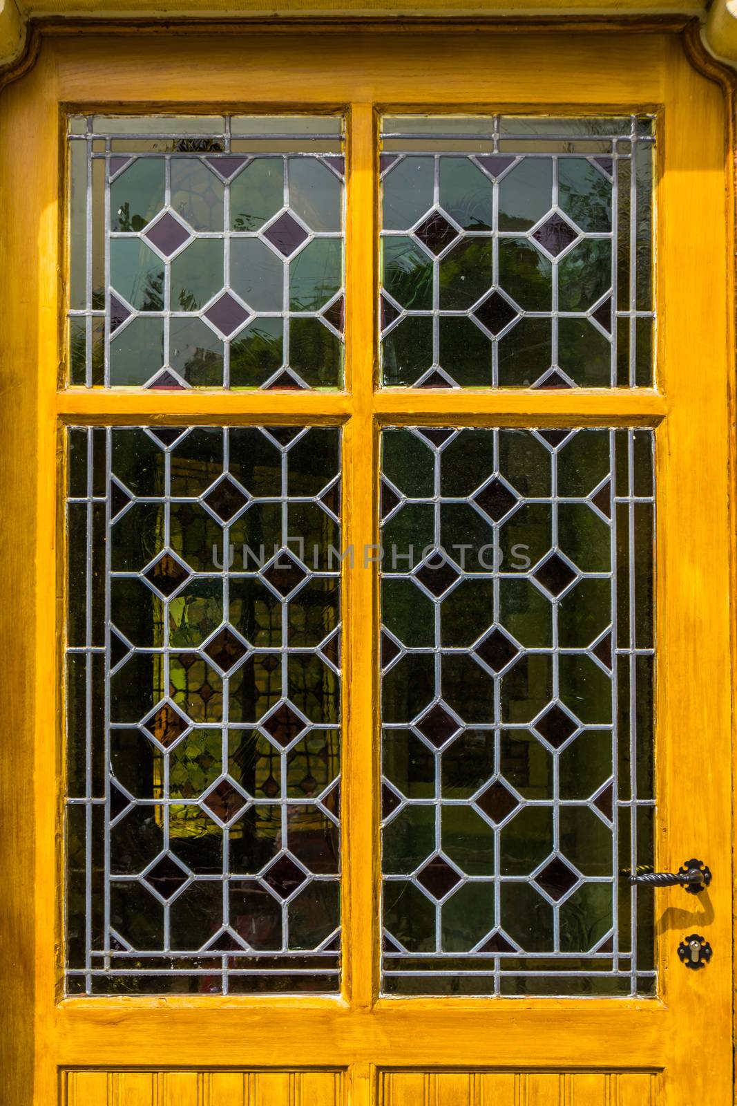 wooden yellow door with tainted glass pattern in diverse colors, Vintage background by charlottebleijenberg