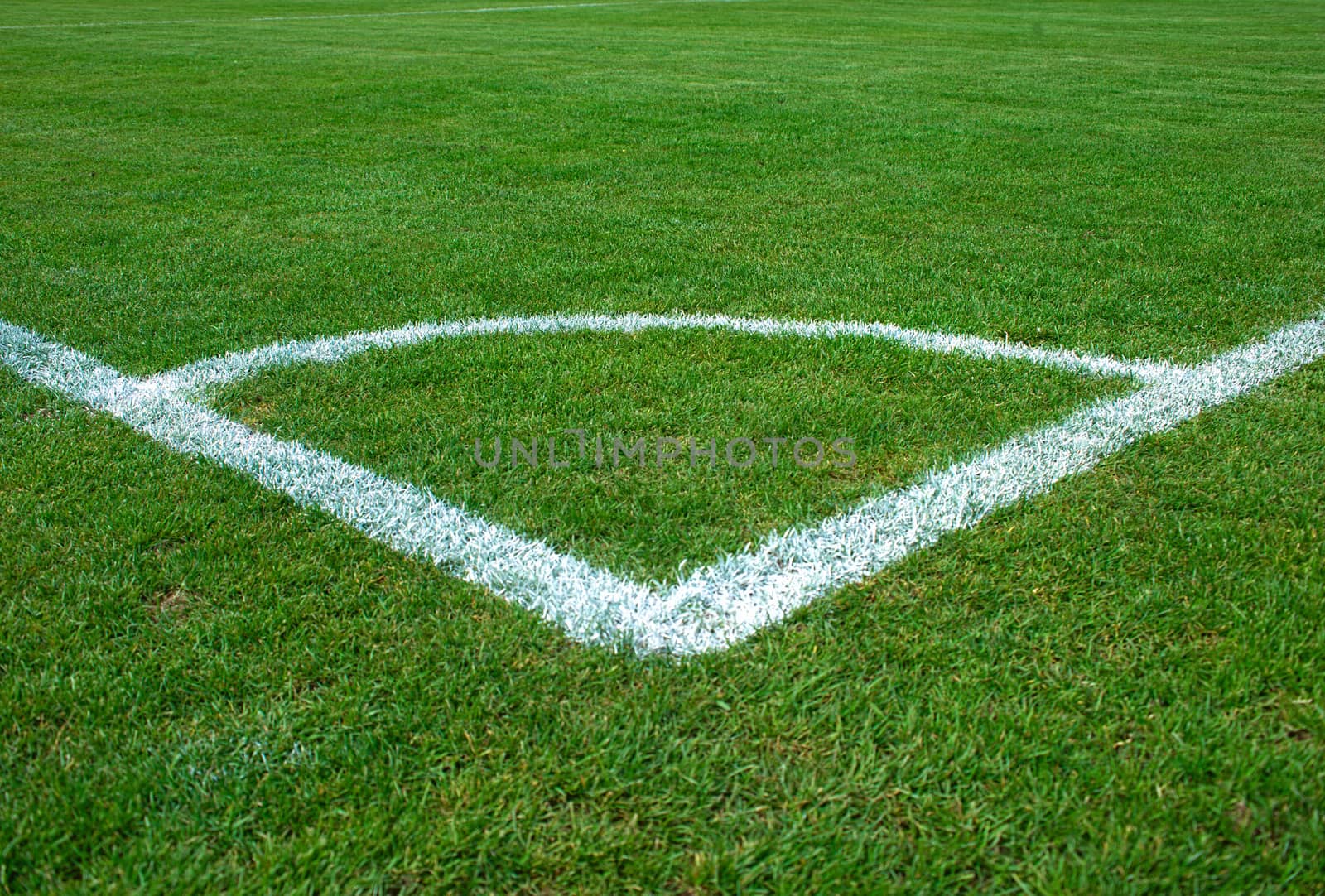 White corner lines on empty soccer grass field by sheriffkule