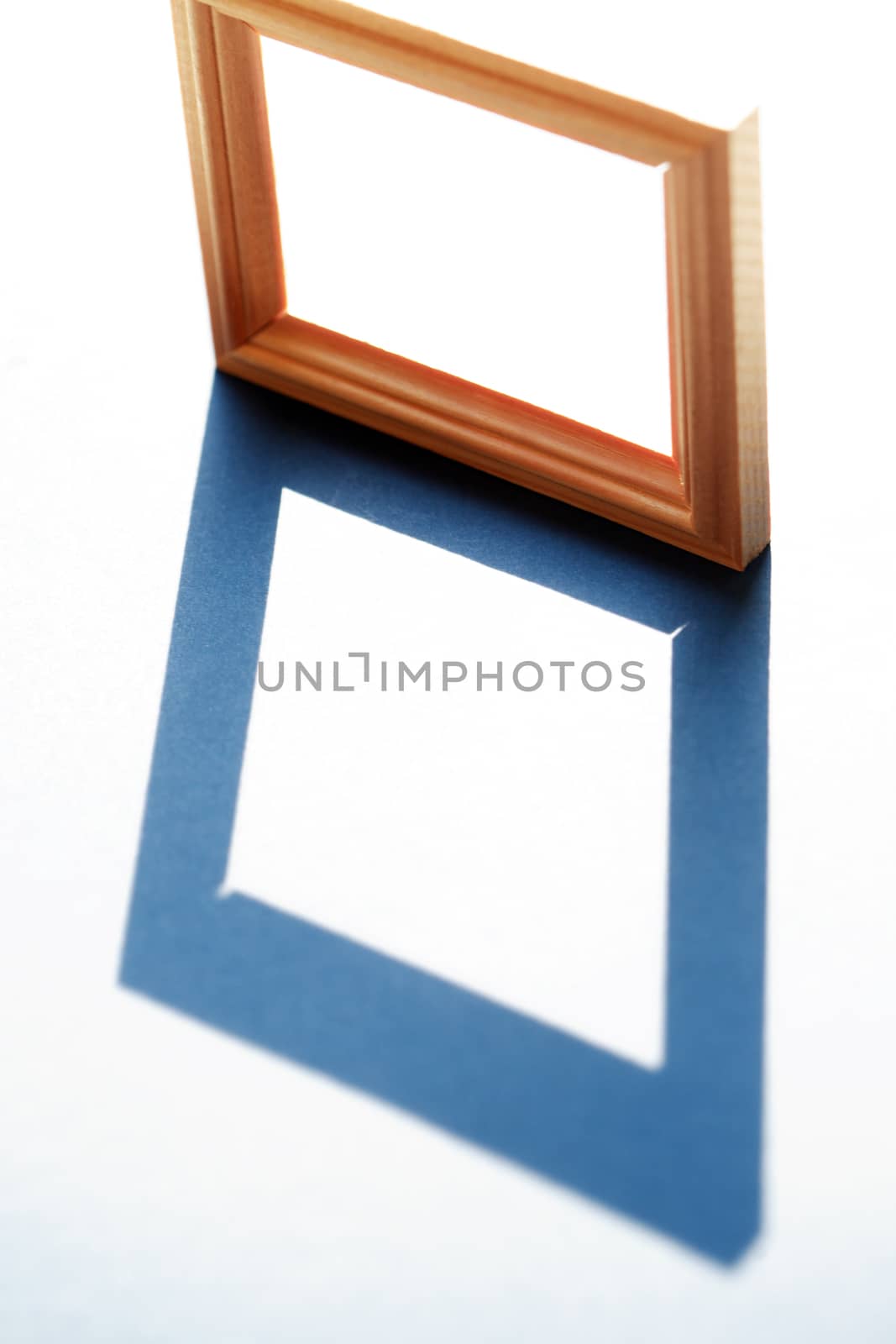 Empty wooden frame with long shadow against sunlight