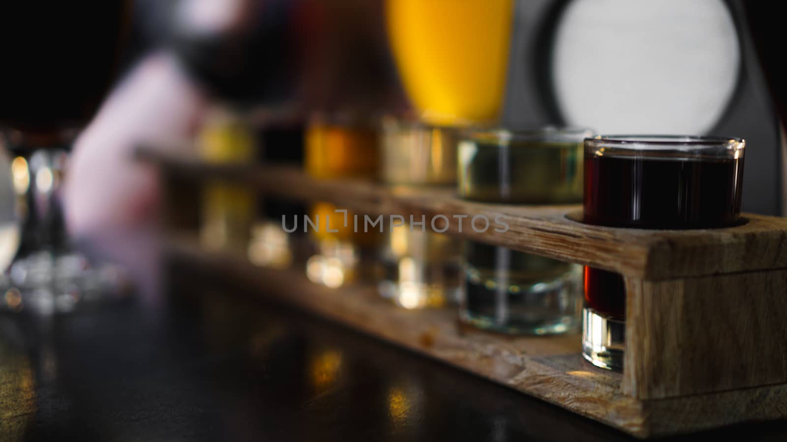 Multicolored cocktails, set of shots in one row, six servings on a wooden stand by natali_brill