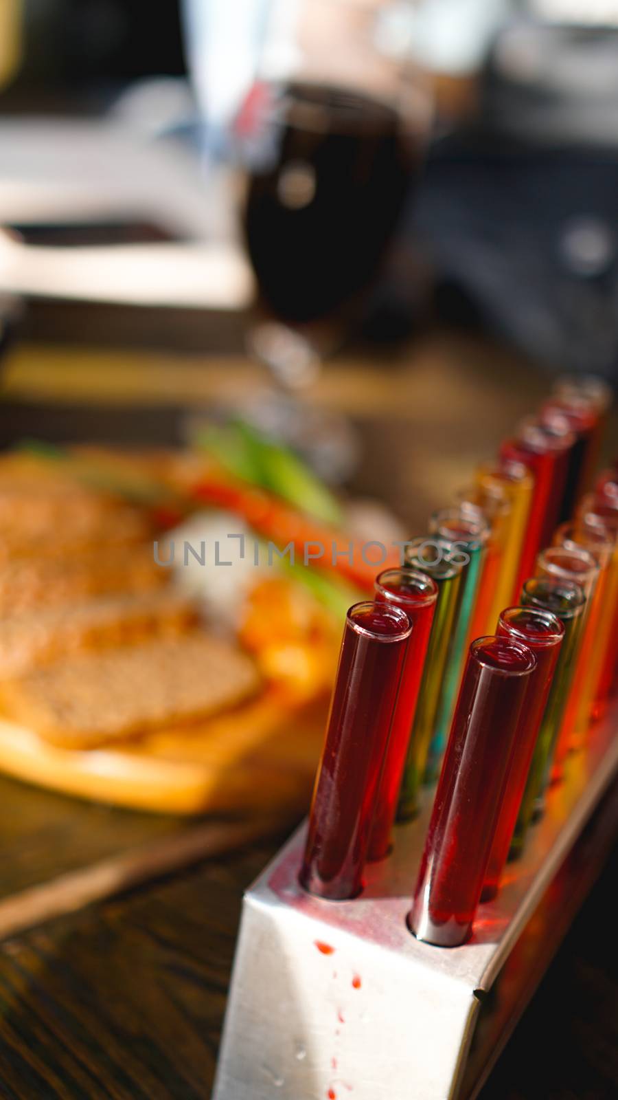 Test tubes with multi-colored liquid. Alcohol in test tubes dark bar. Photo from the bar in Lviv Ukraine