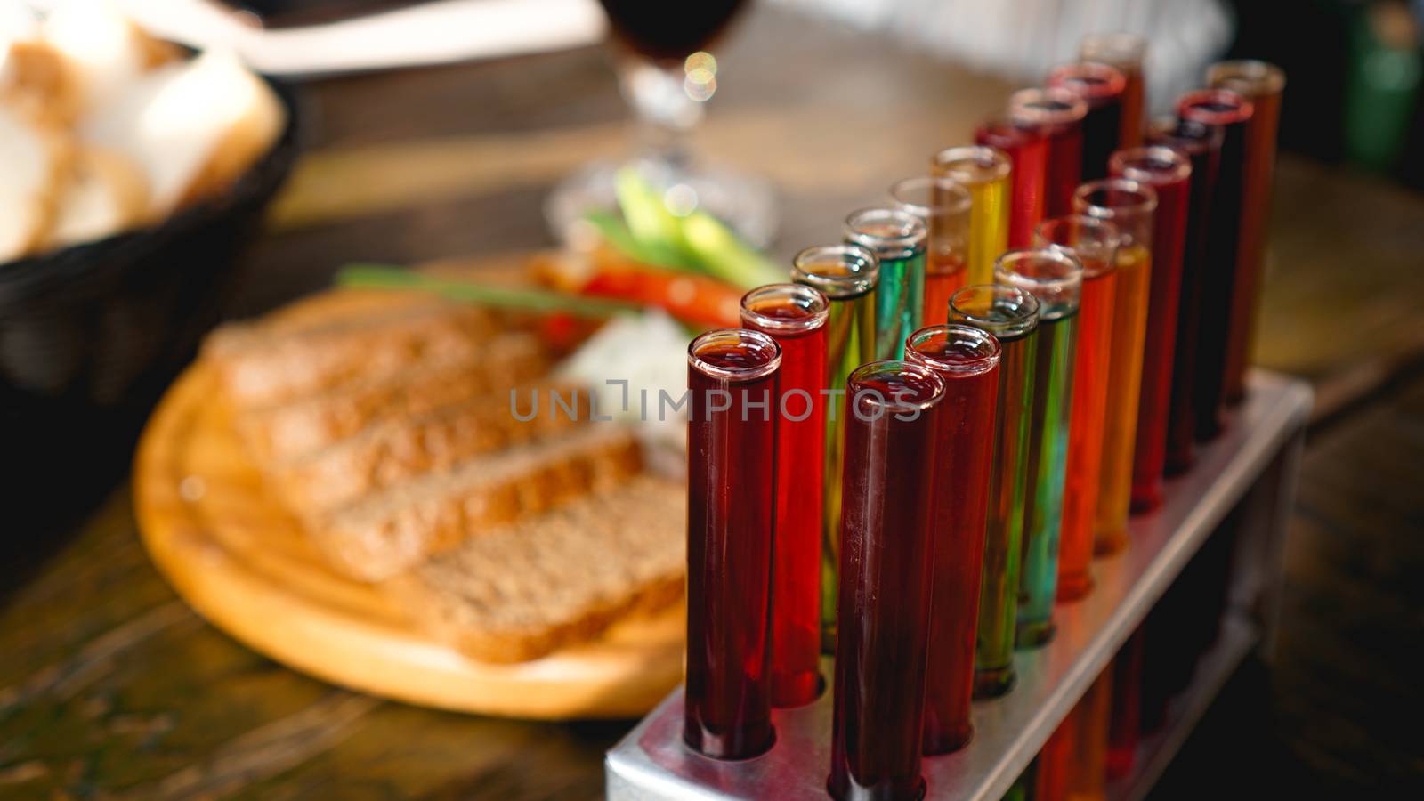 Test tubes with multi-colored liquid. Alcohol in test tubes dark bar. Photo from the bar in Lviv Ukraine