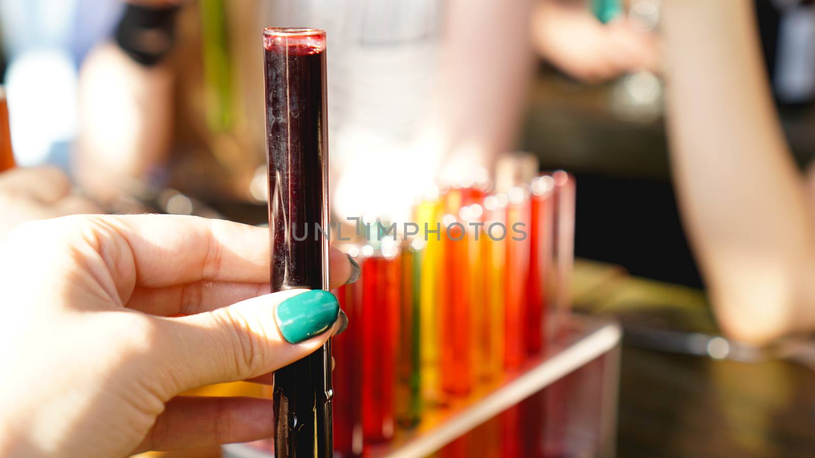 Test tubes with multi-colored liquid. Alcohol in test tubes dark bar by natali_brill