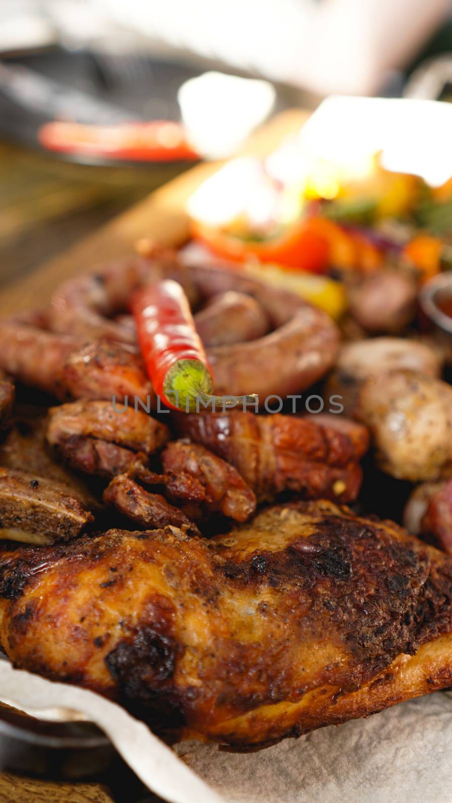Mixed grilled meat platter. Assorted delicious grilled meat with vegetable. Mixed grilled meat with pepper sauce and vegetables.