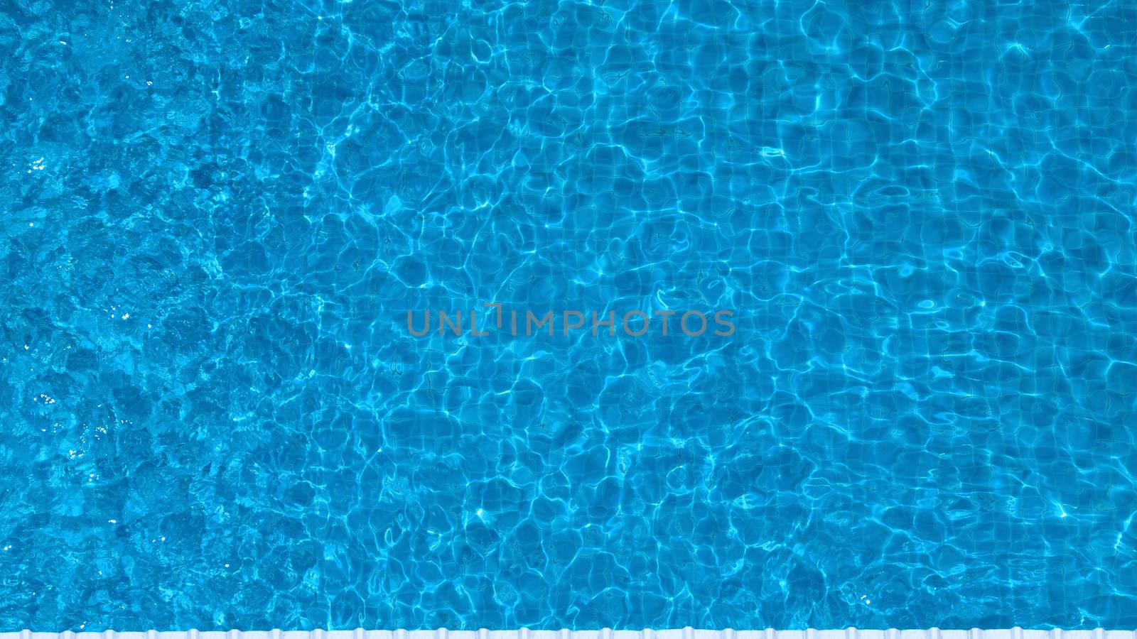 Swimming pool top view angle which blue color clear water and sun light reflect on surface texture and concept images for relaxation or vacation or sport in the tropical summer and for healthy lifestyle