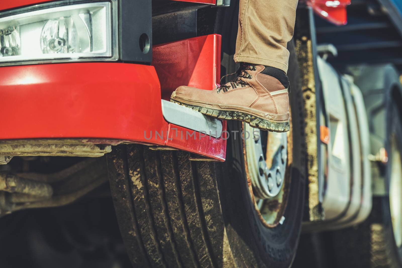 Trucker Getting in the Truck. Driver Shoe and Leg Closeup. Long Haul Transportation.