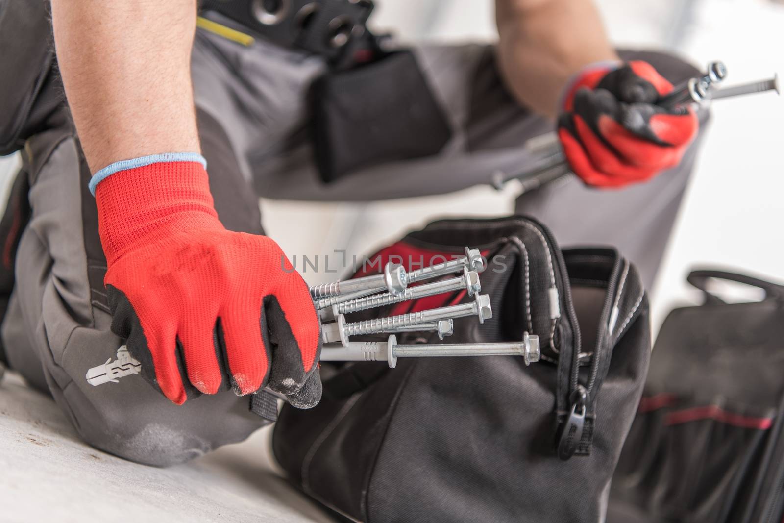 Construction Screws and Bolts. Contractor Choosing Proper Screw.