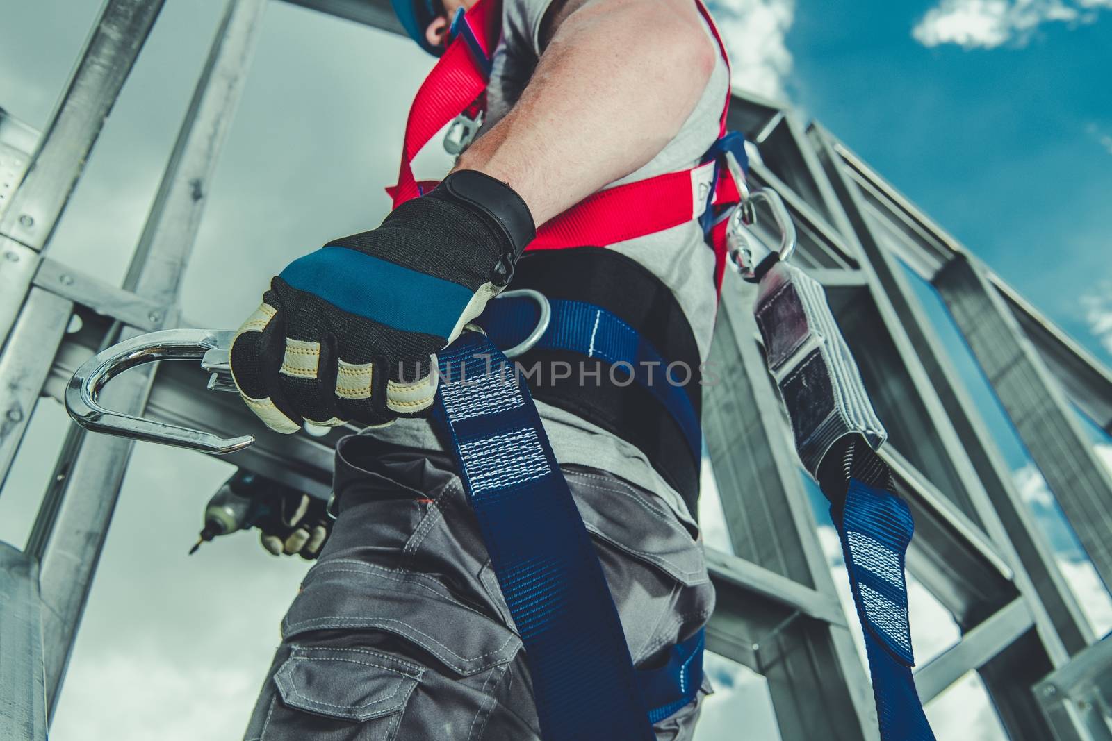 Safety Harness Equipment Closeup. Caucasian Contractor in His 30s on a Steel Building Frame. Working At Height Concept.