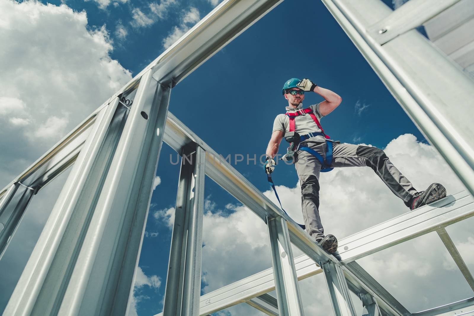 Shock Absorbing Lanyard and Safety Harness Equipment. Work at Height Safety. Caucasian Contractor on a Steel Building Frame.