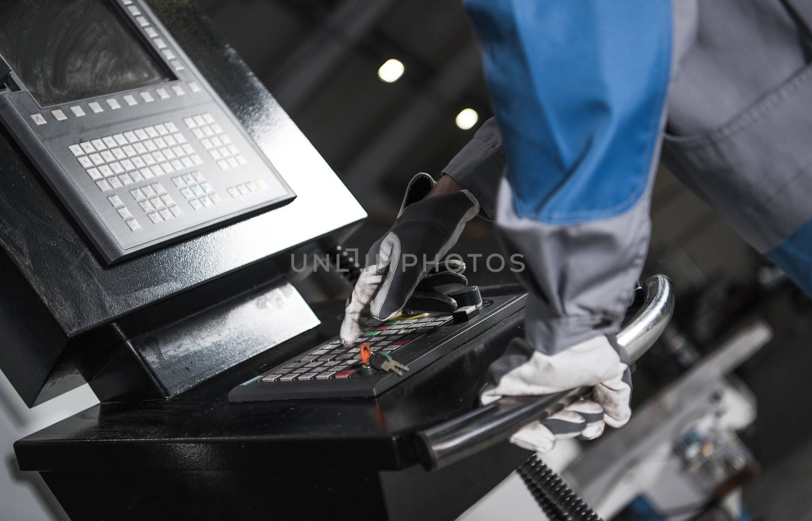 CNC Machine Control Panel Operator Closeup Photo. Metalworking and Manufacturing Concept Photo.