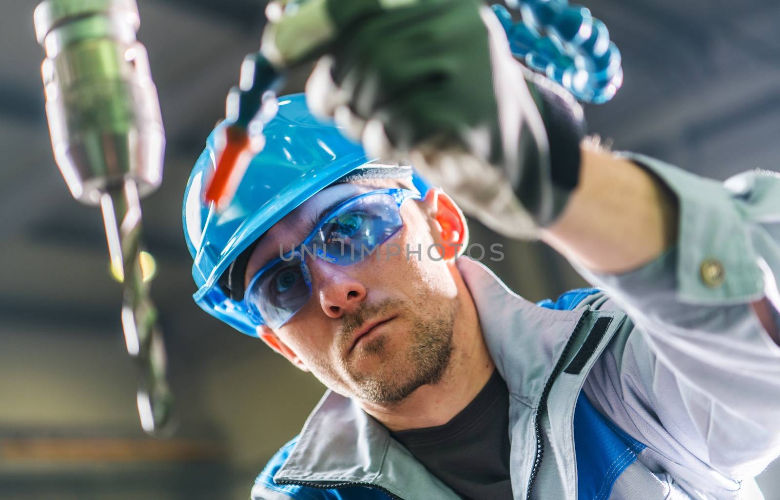 Drilling Technician at Work. Metalworking Theme. Large Heavy Duty Drill Closeup