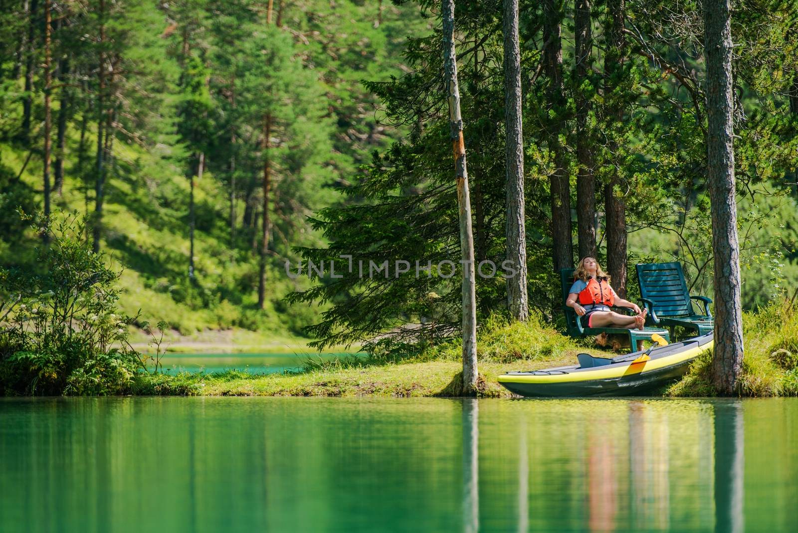 Vacation with the Kayak. Caucasian Woman in Her 30s Relaxing on the Small Lake Island.