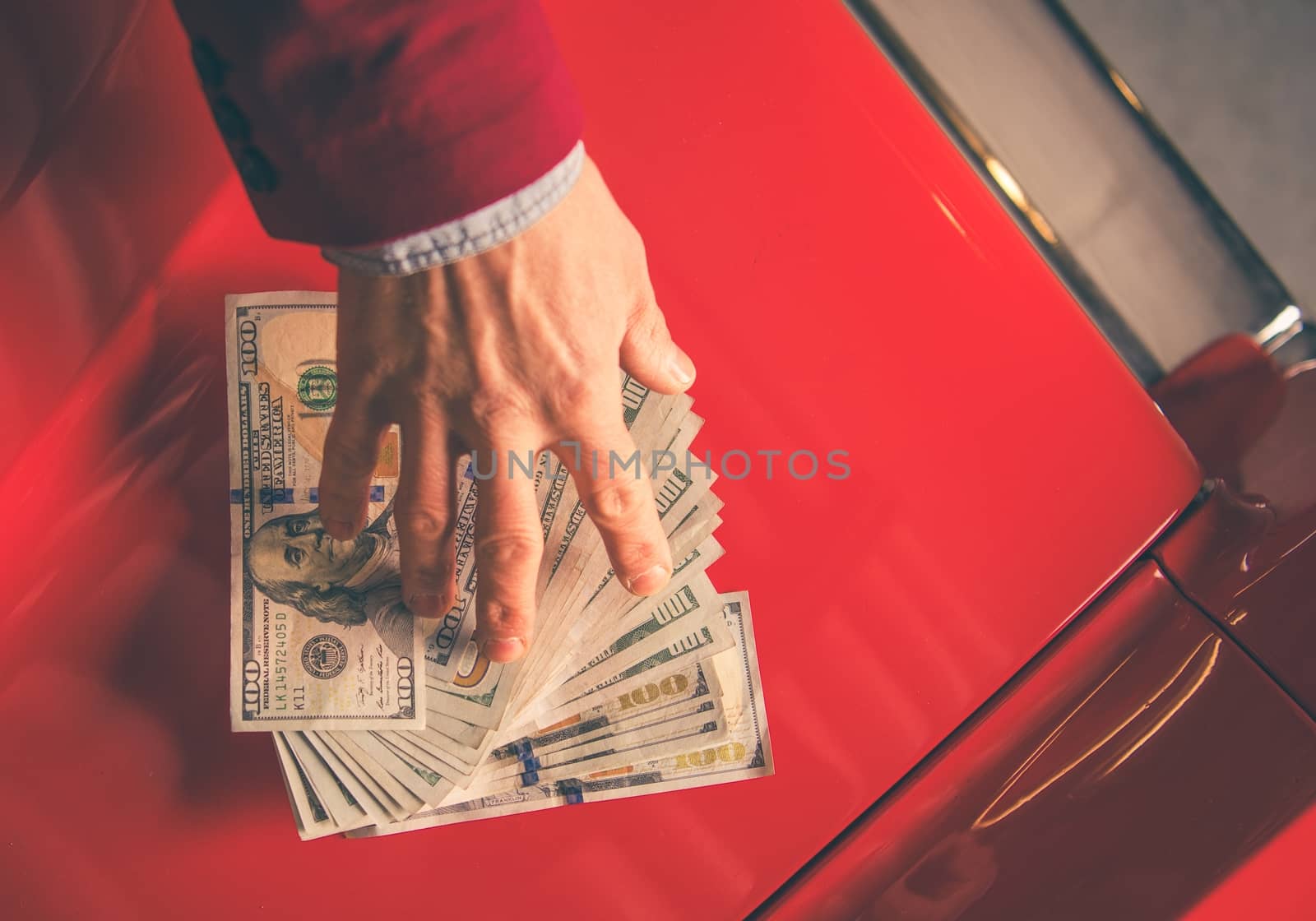 Paying For the Car. Caucasian Men Giving Thousand Dollars For the Aged Classic Car.