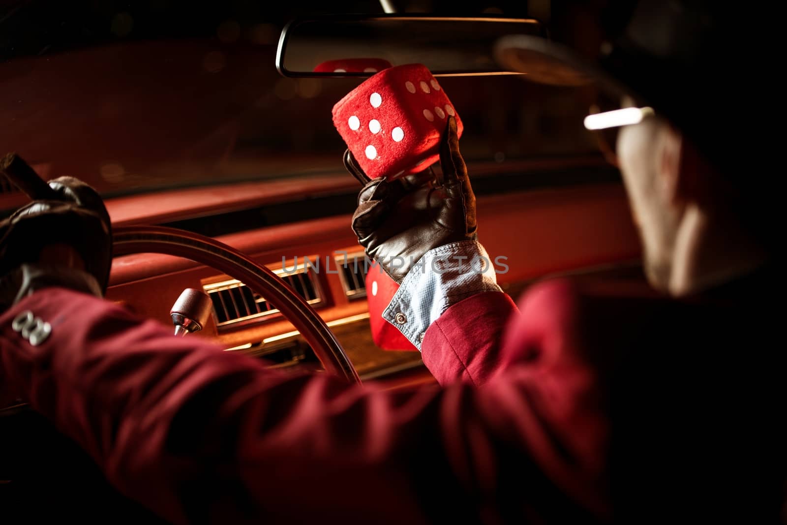 Casino Lucky Wish Concept. Casino Poker Player Talking to His Lucky Red Dice Inside the Classic Car.