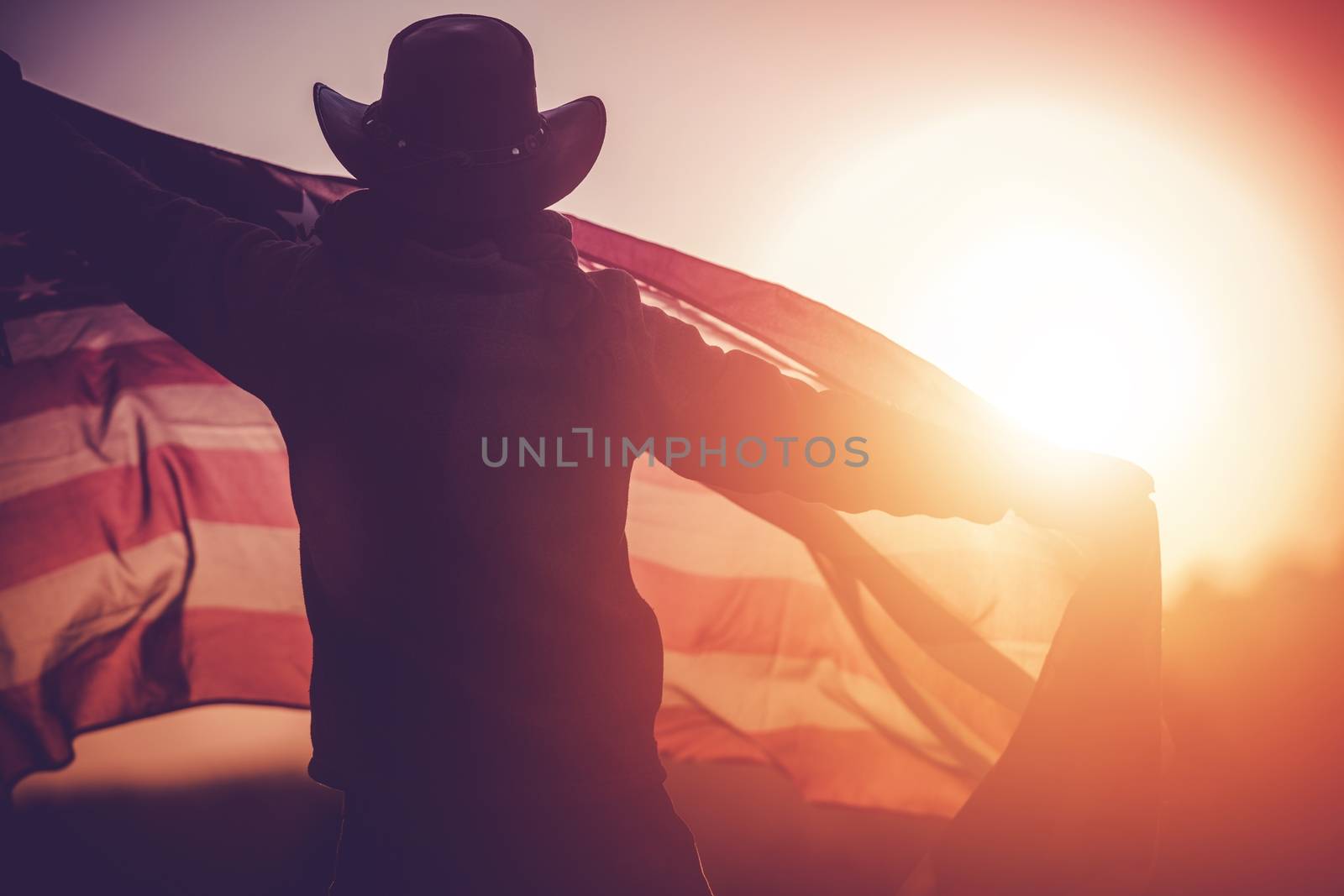Independence Day Celebration. Western Wear Men in Cowboy Hat with United States of American Flag Celebrating 4th of July.