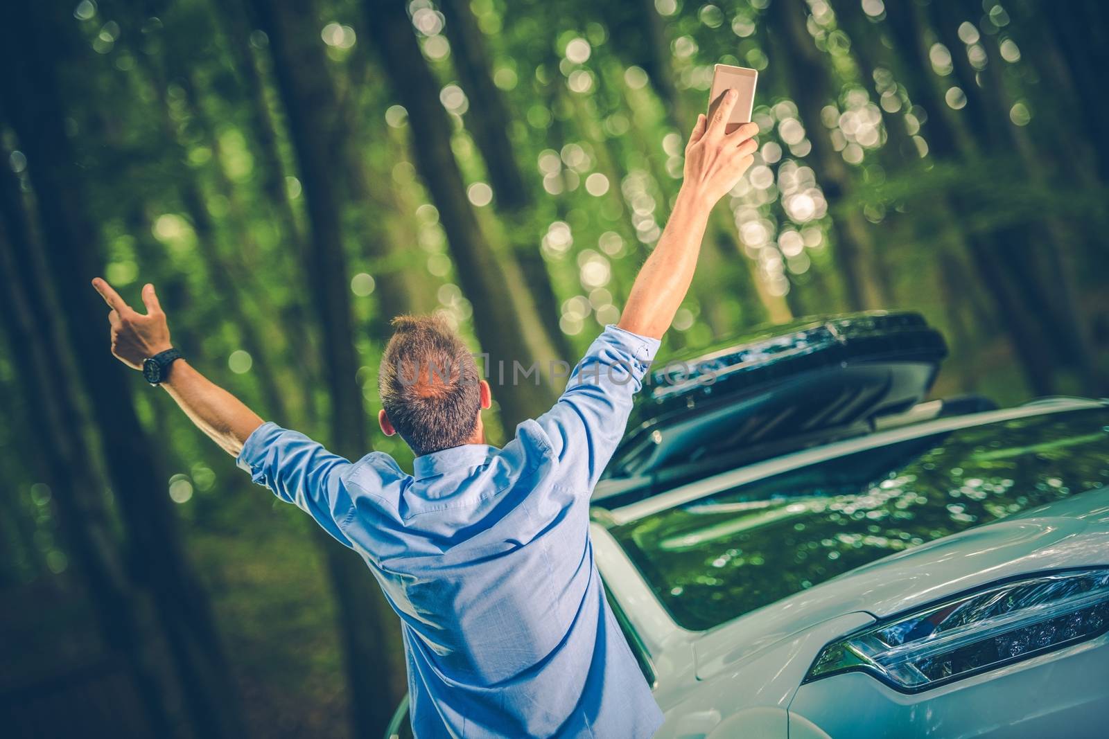 Business Freedom Concept Photo with Young Caucasian Businessman with His Hands in the Air Exited to Be Out of His Office. 