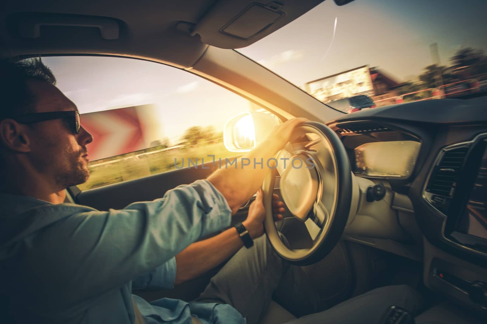 Car Drive with Motion Blur. Dynamic Driving on the Corners. Caucasian Driver in His 30s Inside the Modern Car.
