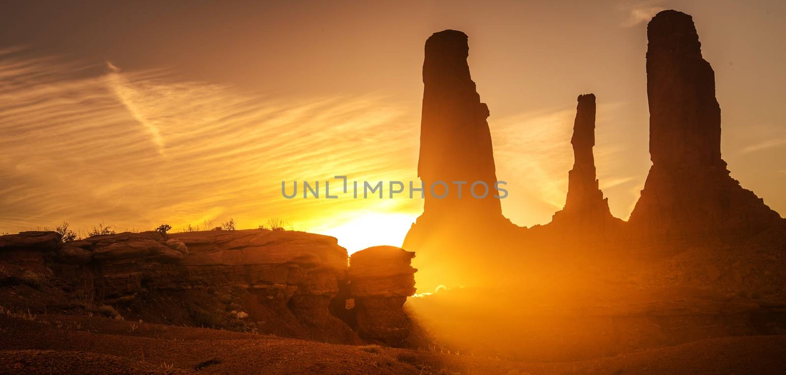 Raw Arizona Sunset. Scenic Sunlight in the Monuments Valley, United States. Rocky Sandstone Formations. Panoramic Photo.