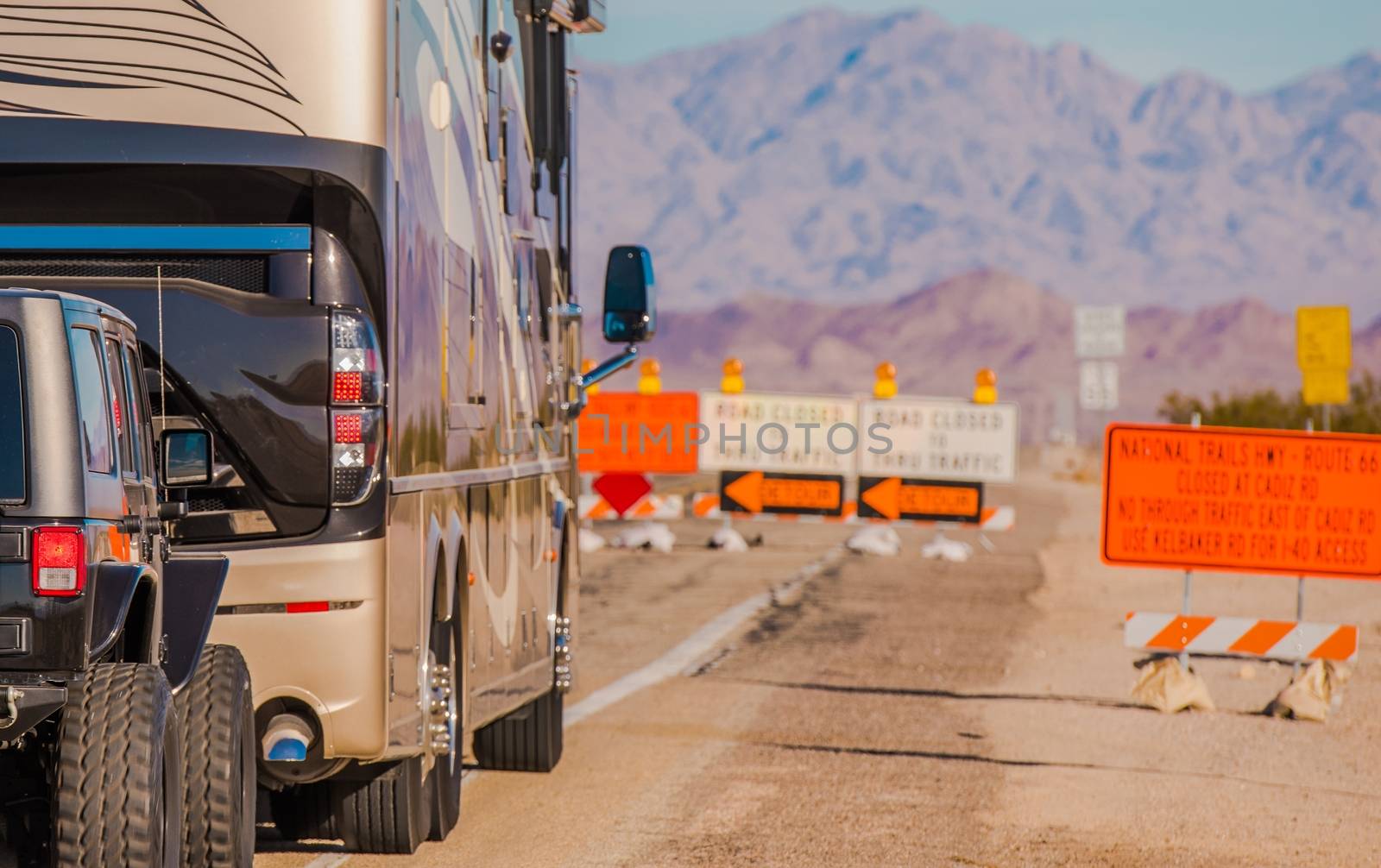 Summer Time Road Constructions. Class A Diesel Pusher Motorhome with Tow Vehicle Avoiding Highway Reconstruction. 