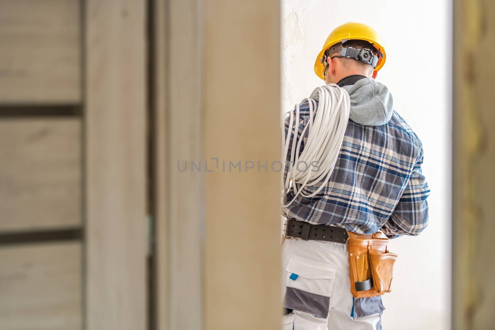 Electrical Systems Installer. Caucasian Electric Technician at Work. 