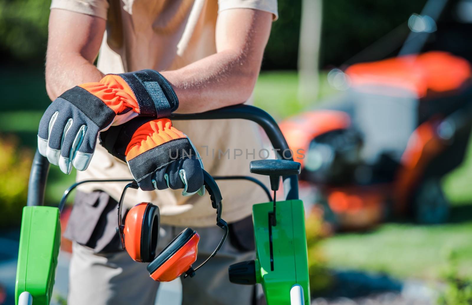 Landscaping Contractor Work. Caucasian Gardener with His Equipment.