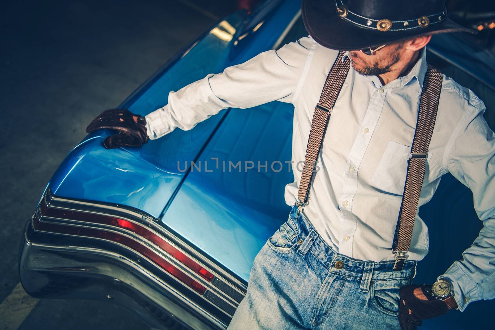 Young Cowboy Driver and His Muscle Classic Car. American Style Driving.