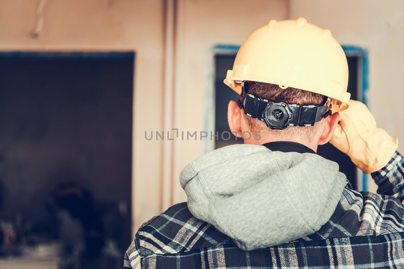 Construction Worker Job. Caucasian Men in Yellow Hard Hat Closeup Photo. 