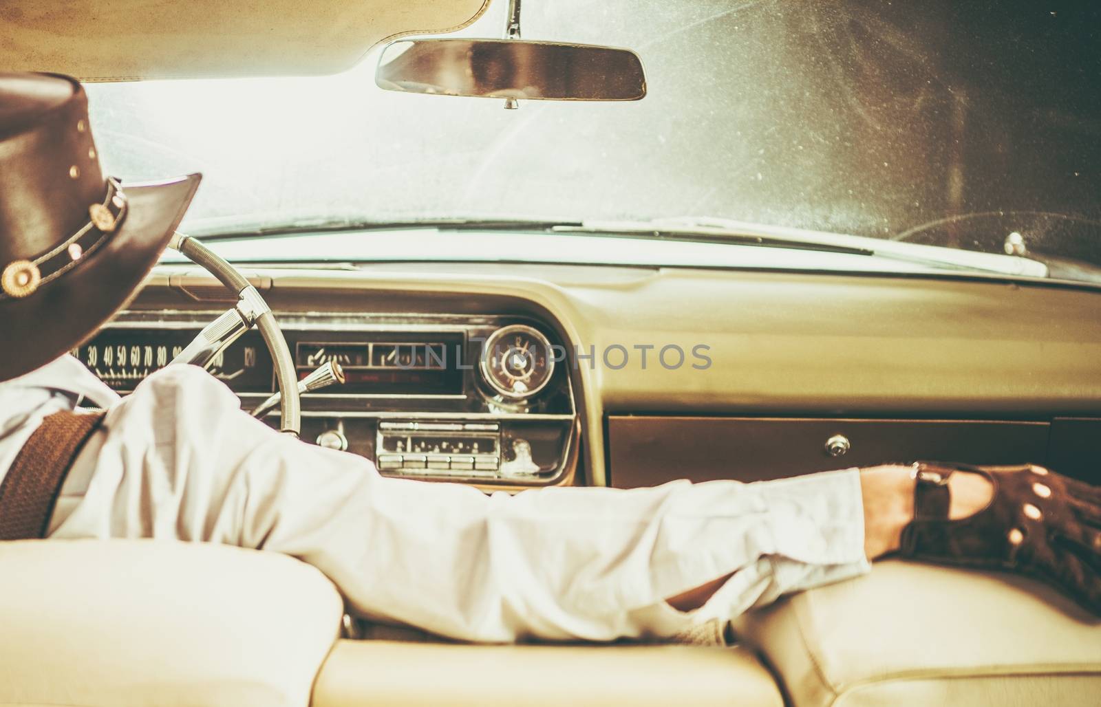 Cowboy on the Road in the Classic Convertible American Vehicle.