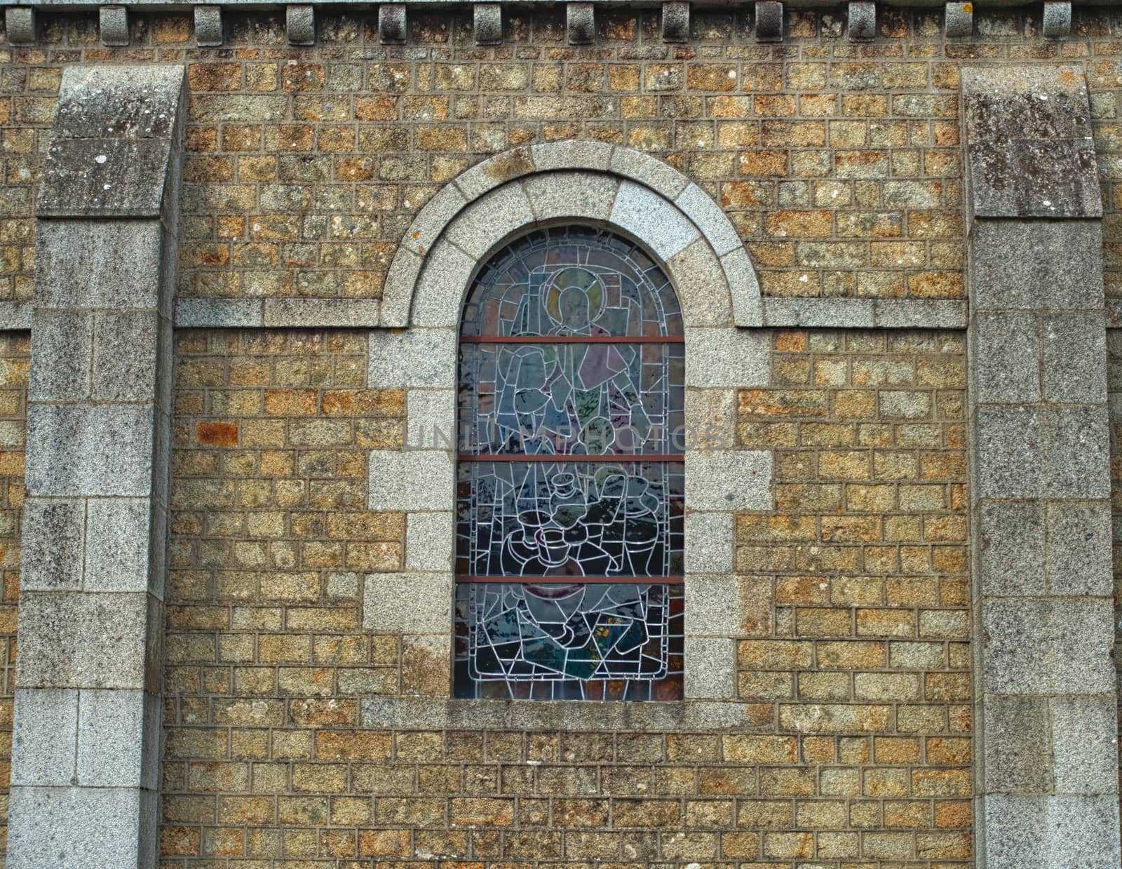 Decorated window on stone bricks wall at cathedral