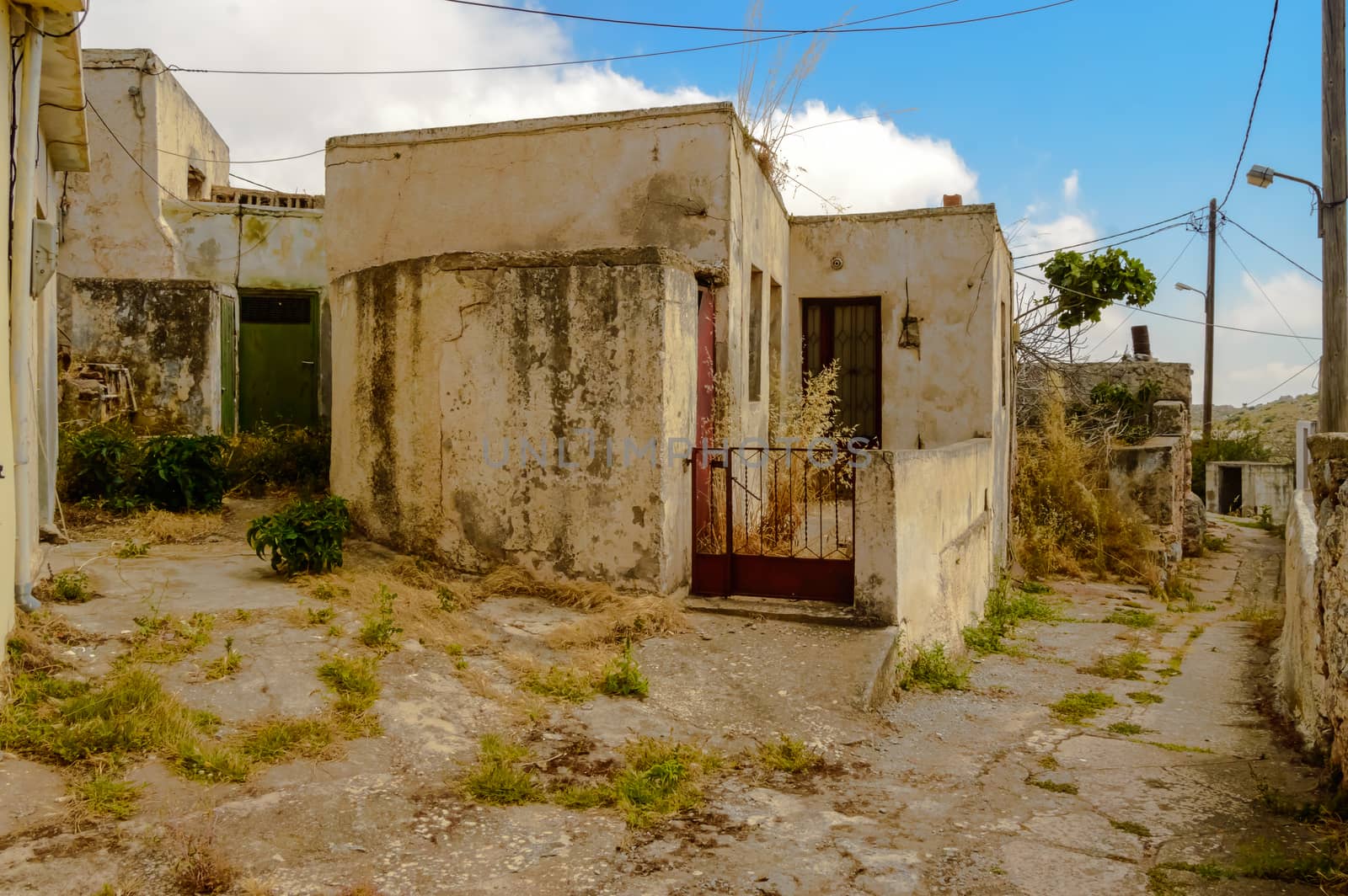 Old abandoned town. Narrow street in old Greek village. Traditional buildings. Destroyed house.  Crete Island, Greece