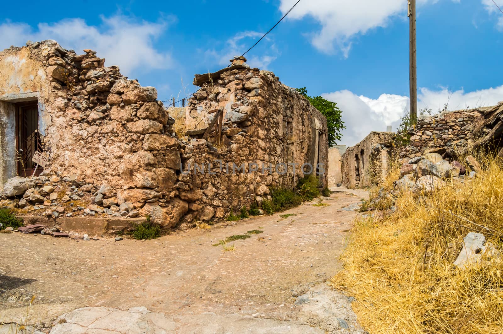 Old abandoned town. Narrow street in old Greek village.  by Philou1000