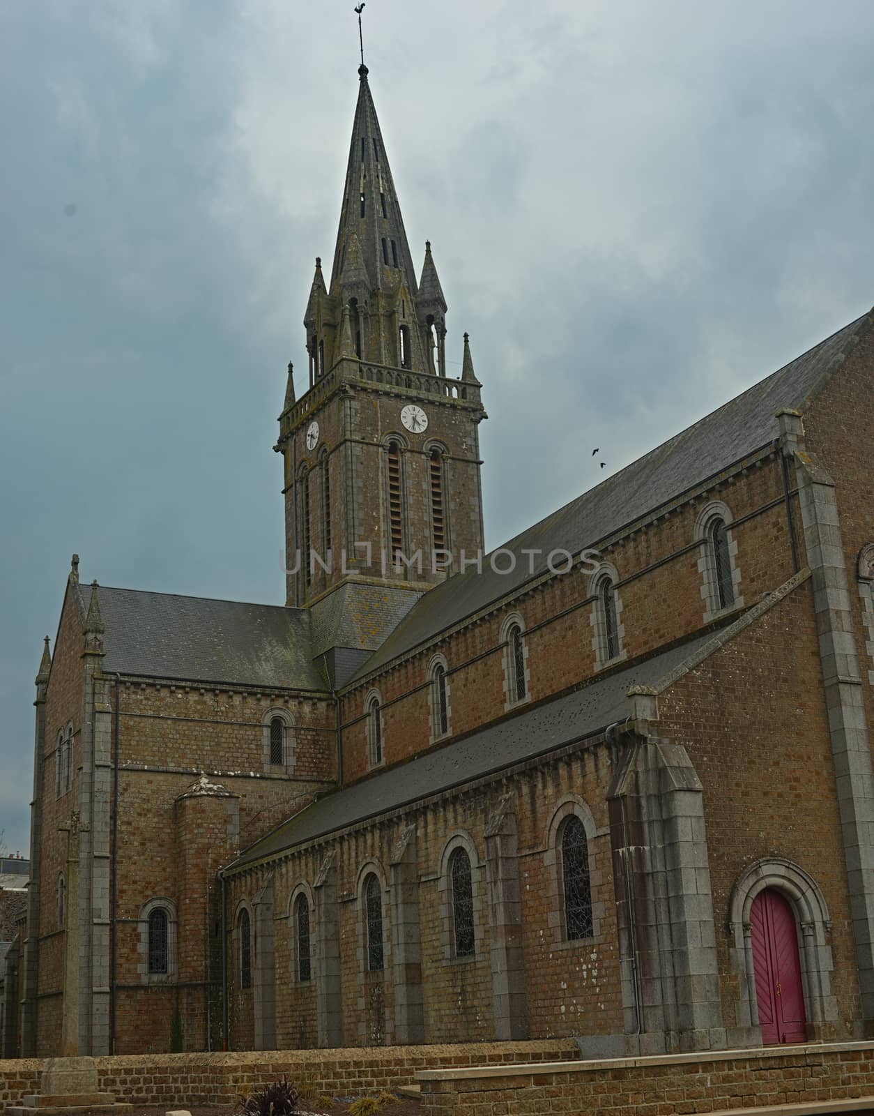 Big old stone Catholic cathedral in Sourdeval Normandy France by sheriffkule