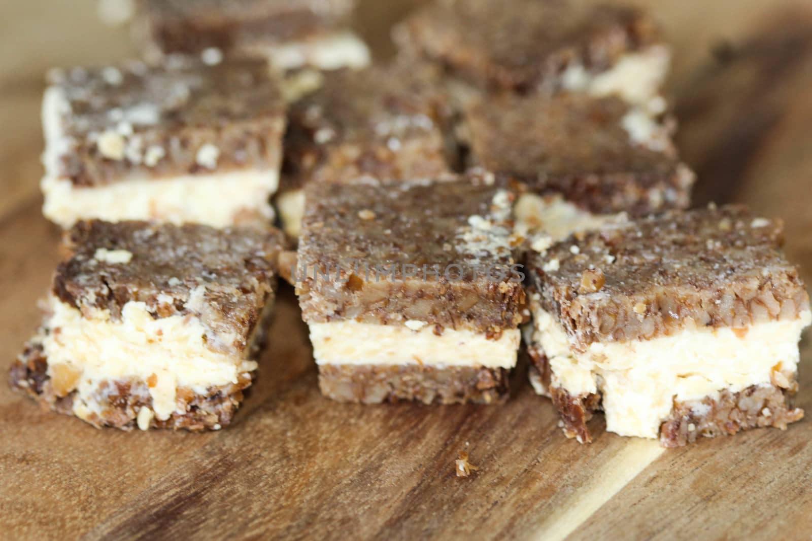 close up of rye bread with aged cheese on wooden background