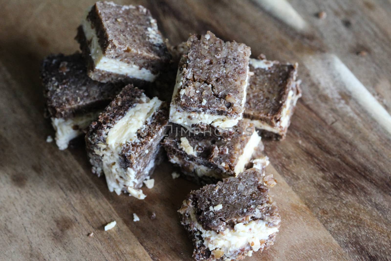 close up of rye bread with aged cheese on wooden background