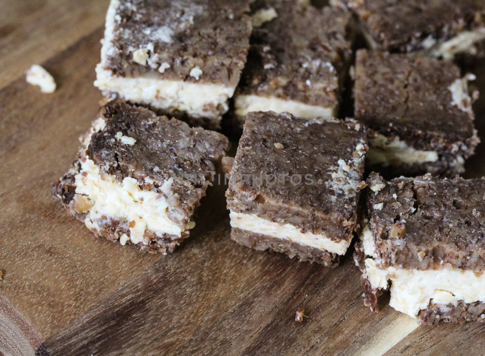 close up of rye bread with aged cheese on wooden background