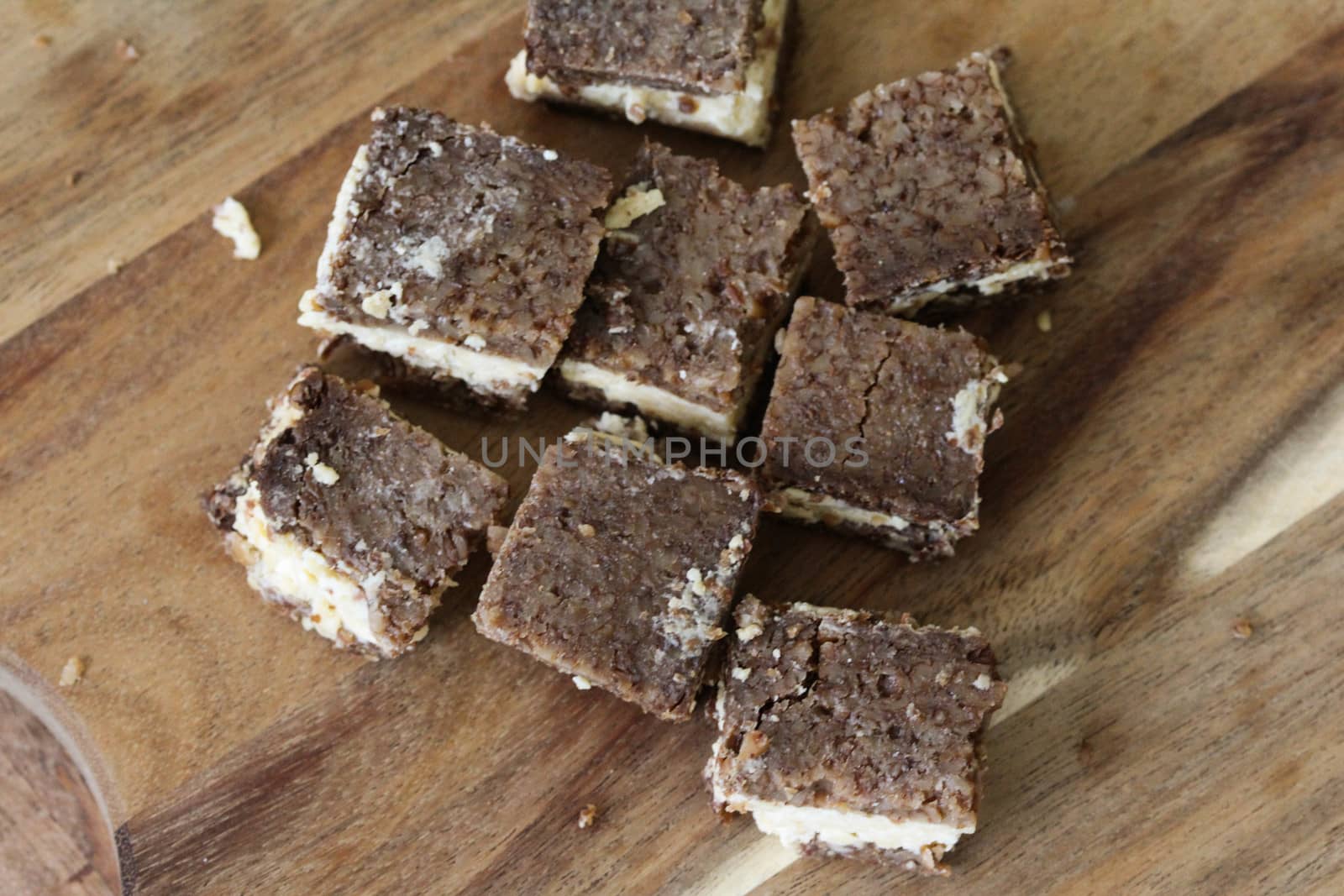 close up of rye bread with aged cheese on wooden background
