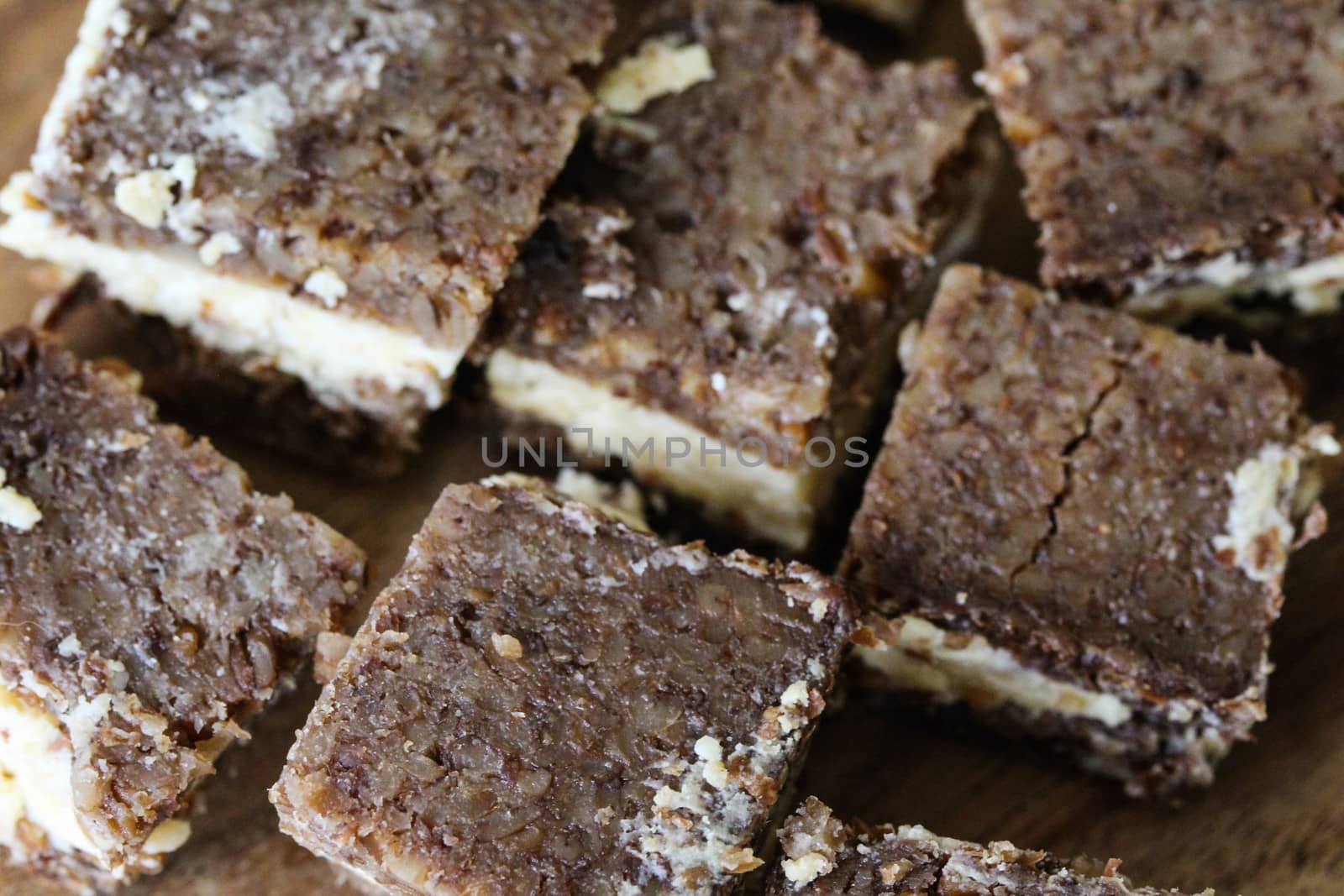close up of rye bread with aged cheese on wooden background