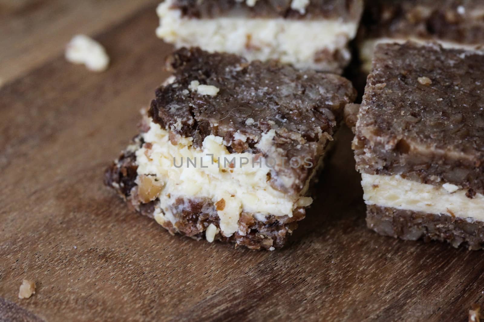 close up of rye bread with aged cheese on wooden background