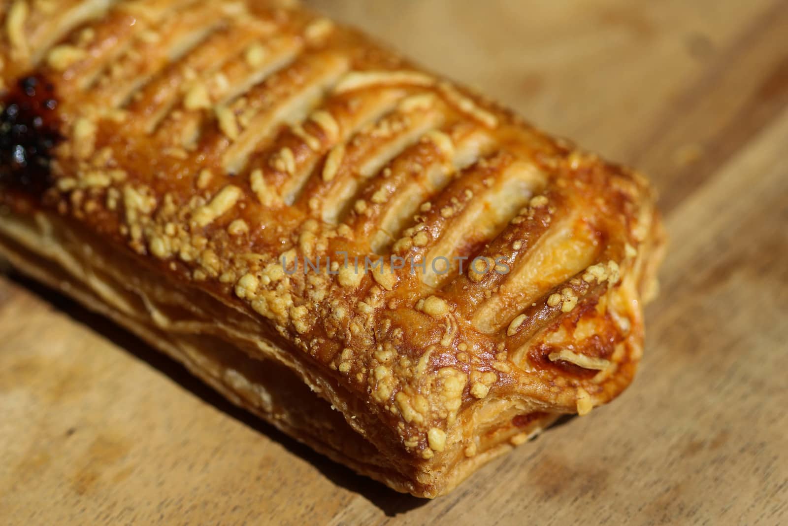 close up of Puff pastry bread filled with cheese, with wooden background