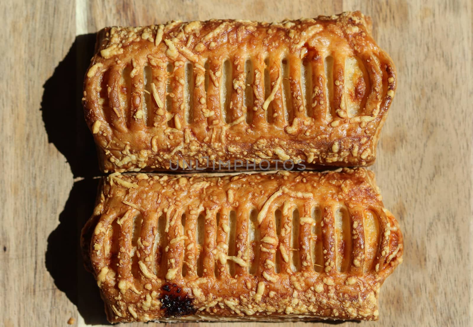 close up of Puff pastry bread filled with cheese, with wooden background