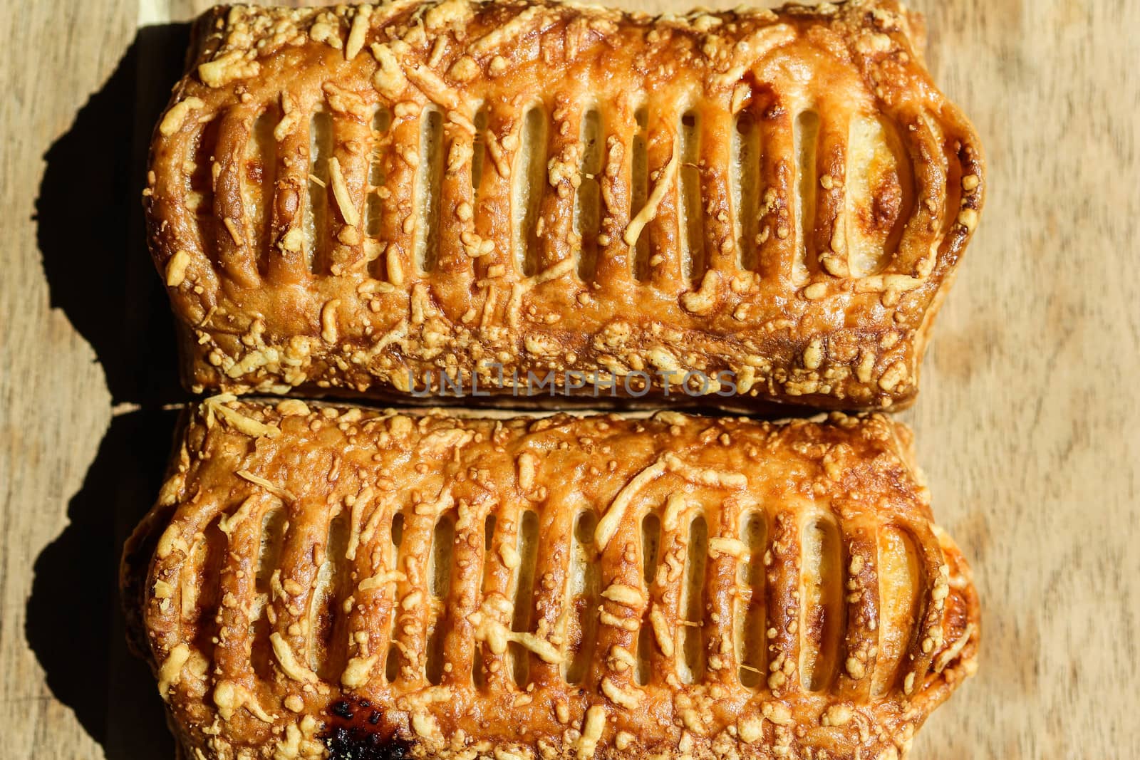 close up of Puff pastry bread filled with cheese, with wooden background