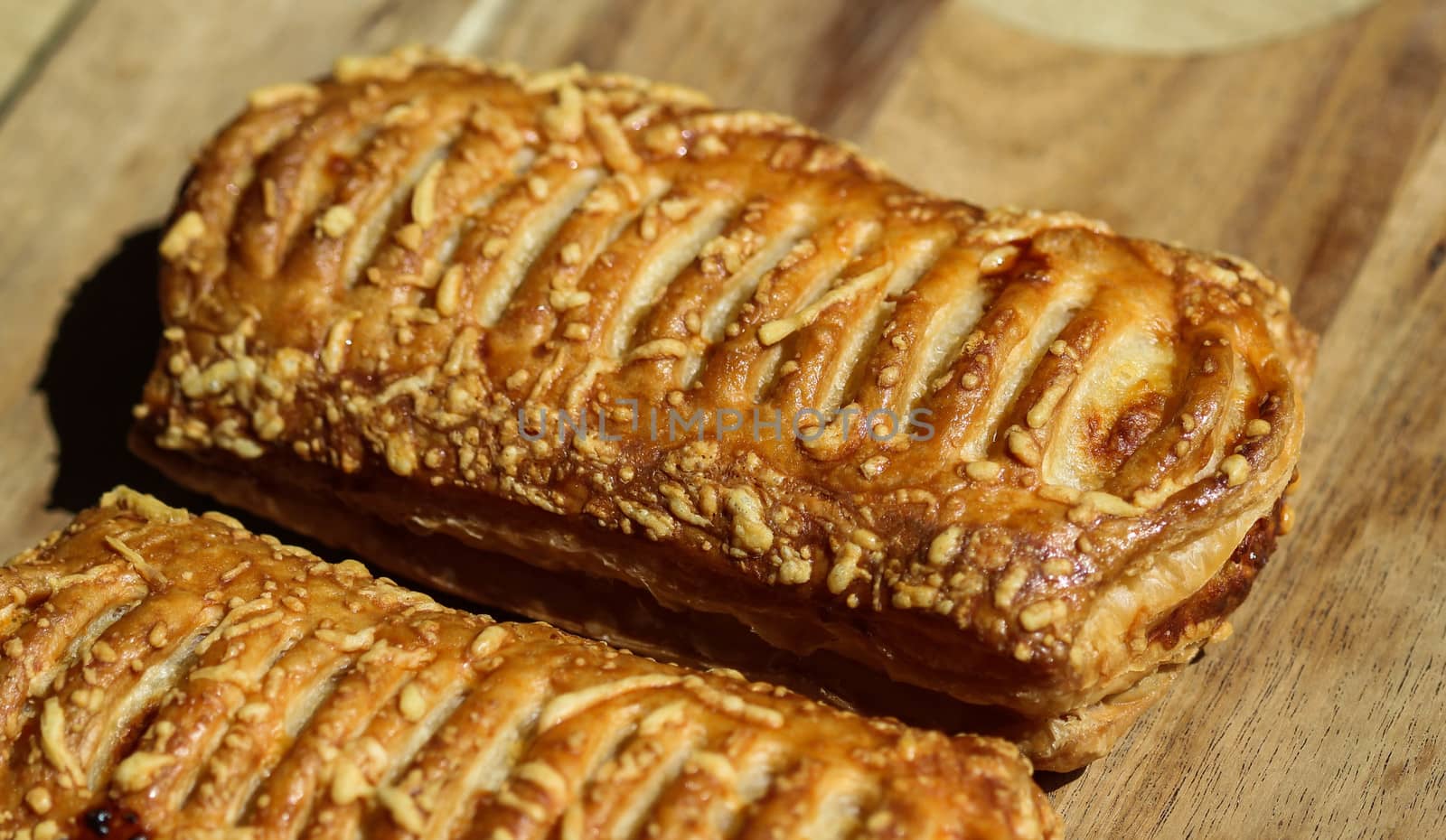 close up of Puff pastry bread filled with cheese, with wooden background