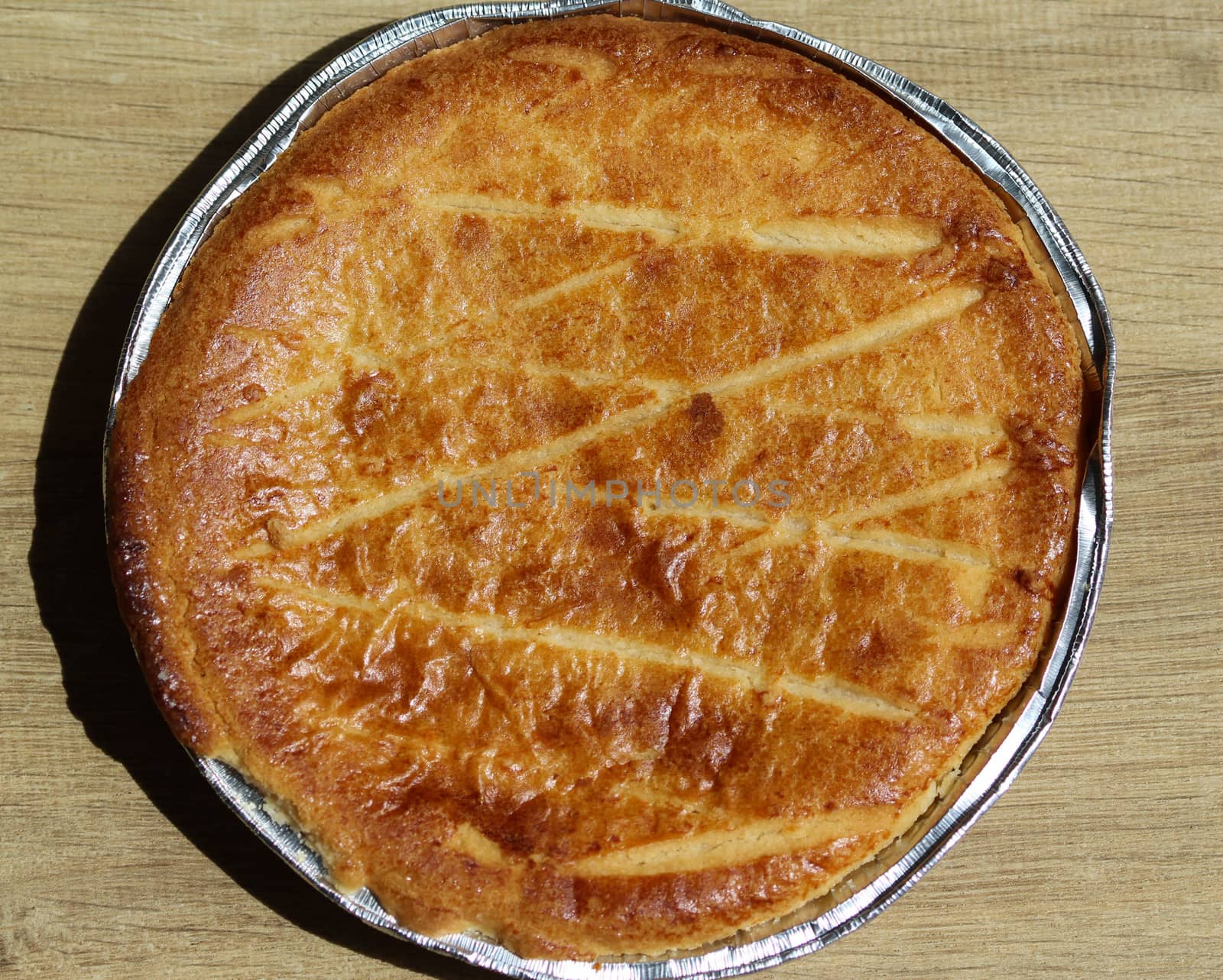 close up of 	
Selfmade Dutch Butter Cake (Boterkoek) cookie, fresh baked from the oven. Displayed on wooden background