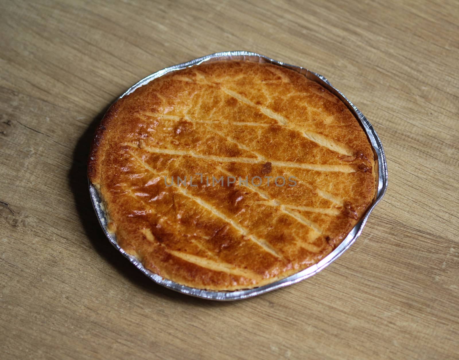 close up of 	
Selfmade Dutch Butter Cake (Boterkoek) cookie, fresh baked from the oven. Displayed on wooden background