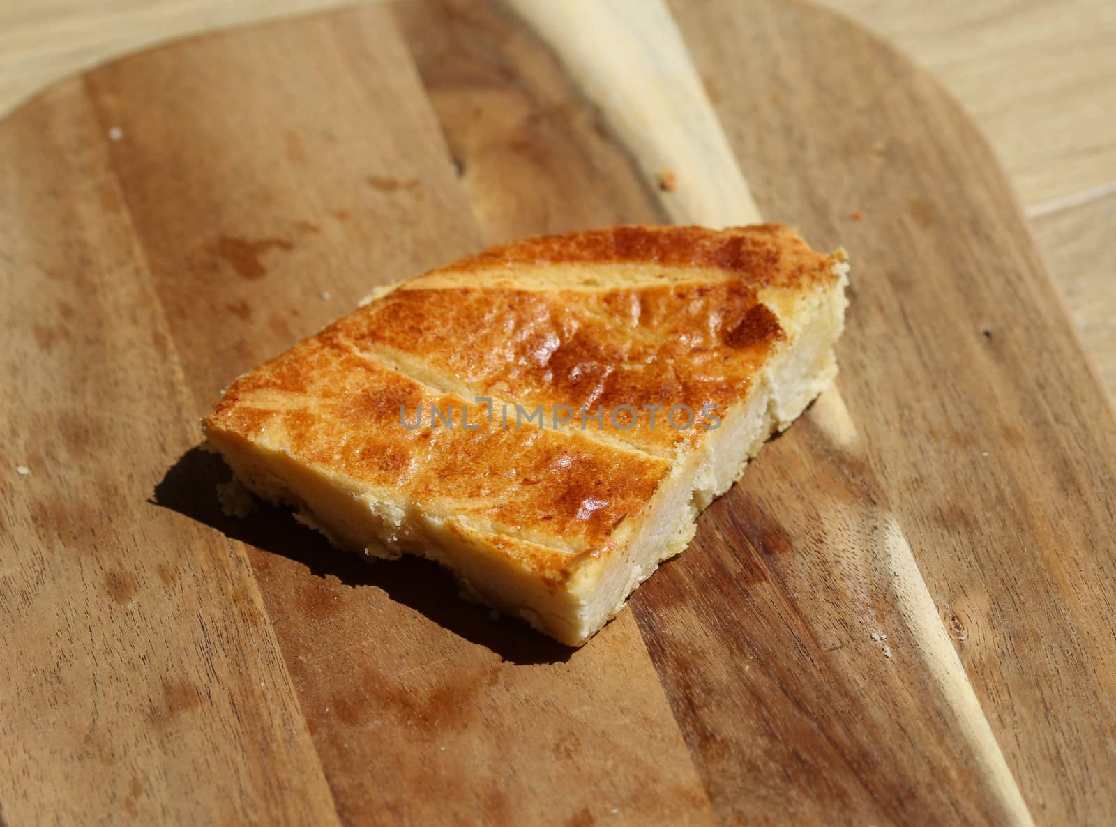 close up of 	
Selfmade Dutch Butter Cake (Boterkoek) cookie, fresh baked from the oven. Displayed on wooden background