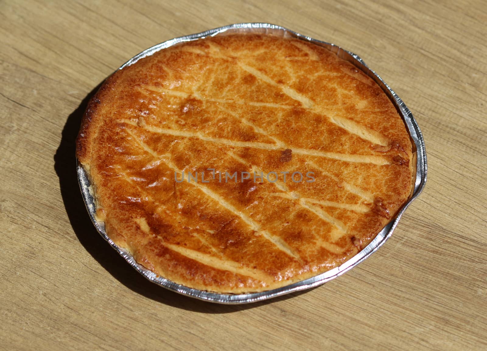 close up of 	
Selfmade Dutch Butter Cake (Boterkoek) cookie, fresh baked from the oven. Displayed on wooden background