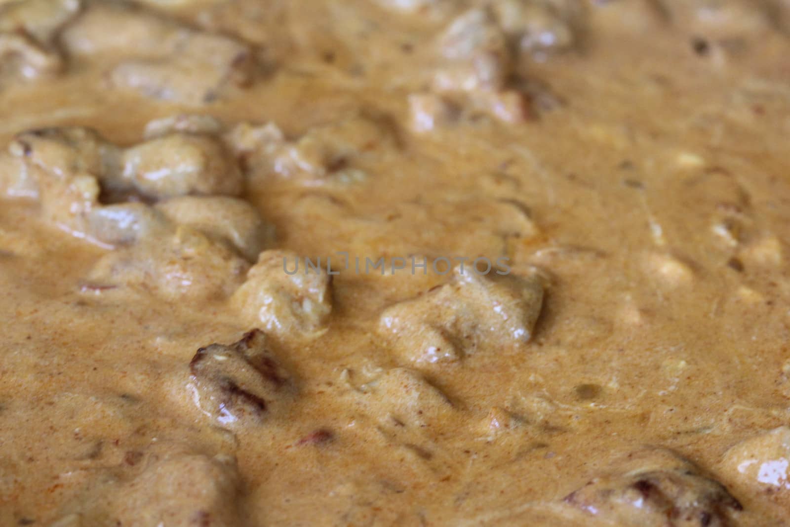 close up of chicken tandoori sauce in pan