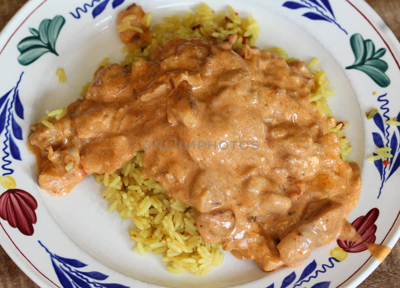 close up of tandoori sauce with yellow rice in kitchen