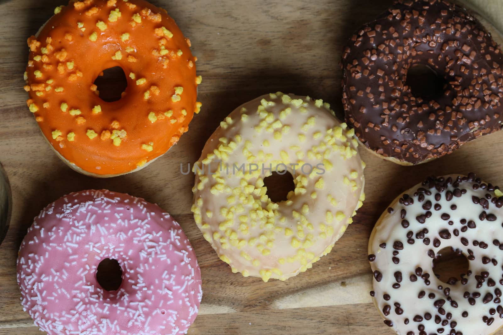 close up of different flavors of donuts
